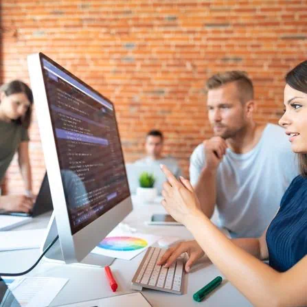 Sirat Graphics Team Working on the code of a website